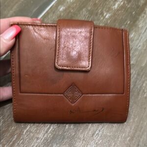 Vintage Brown Leather Wallet with Snap Closure and Embossed Emblem